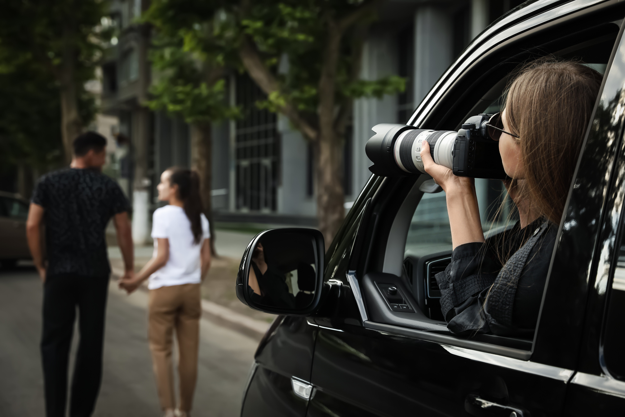 Private Detective with Camera Spying from Car